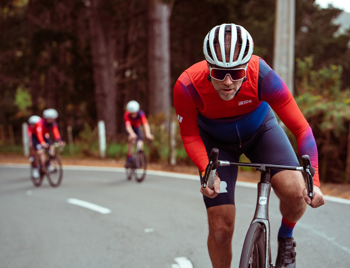 Jamie riding ahead of the group in the red and blue iRIDE kit.